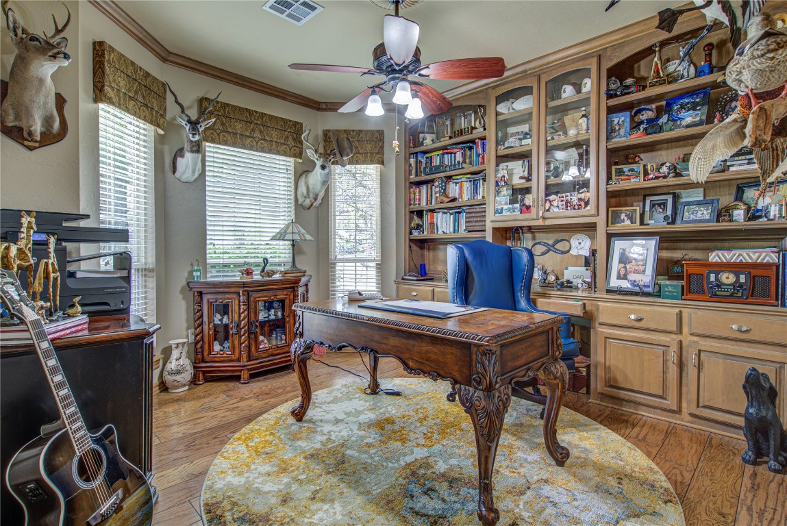 4209 Heavenfield Court, Edmond, OK 73034 home office featuring a wealth of natural light, ornamental molding, and light wood-type flooring