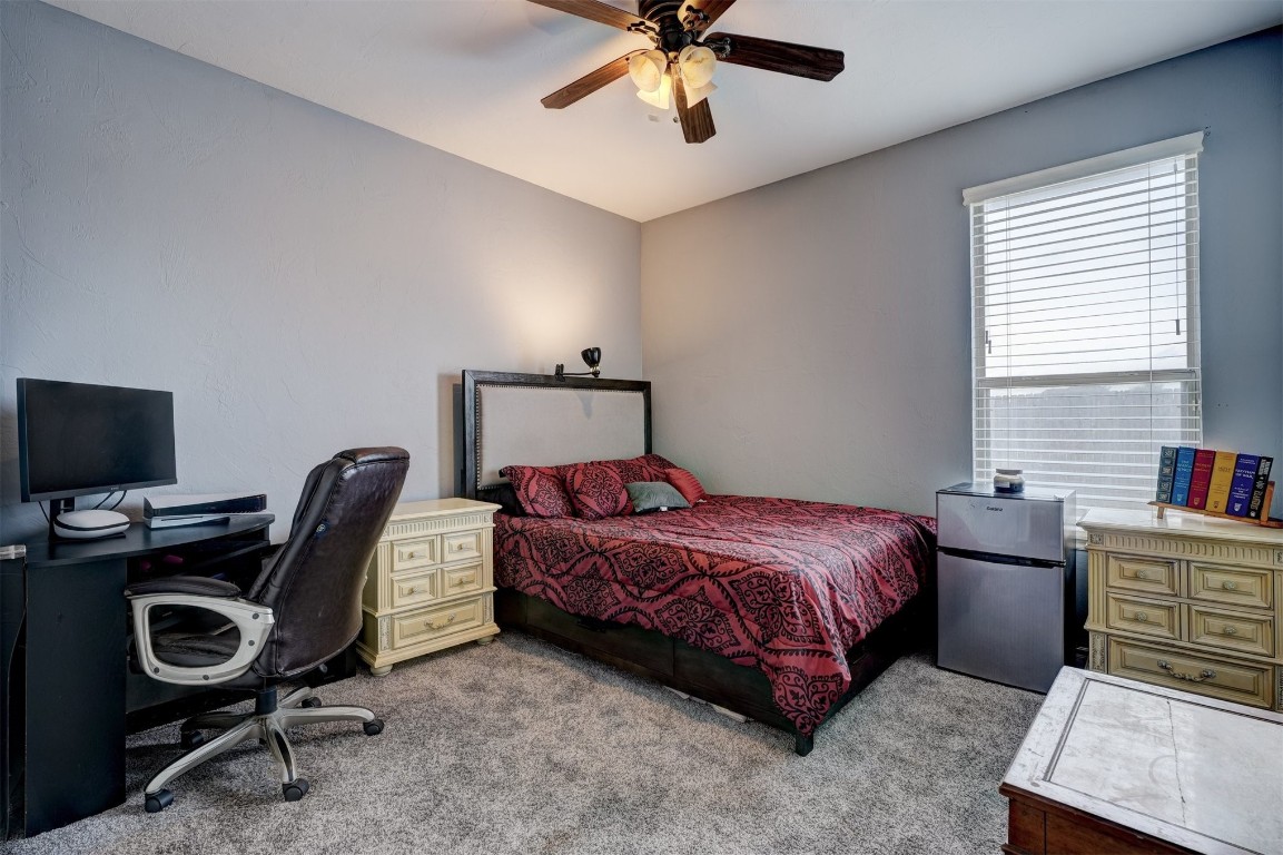 12549 Crick Hollow Court, Oklahoma City, OK 73170 carpeted bedroom featuring ceiling fan