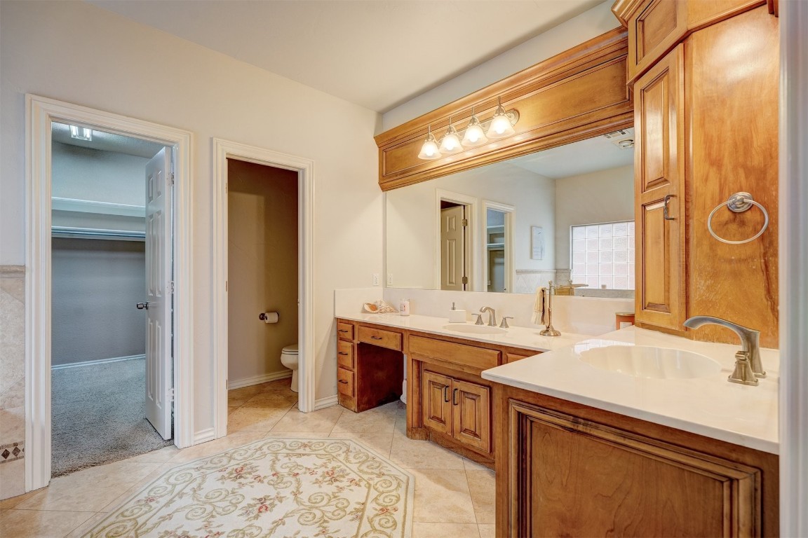 12549 Crick Hollow Court, Oklahoma City, OK 73170 bathroom with vanity, toilet, and tile flooring