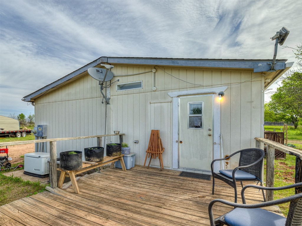 12 Galvin Drive, Guthrie, OK 73044 wooden deck featuring an outdoor structure