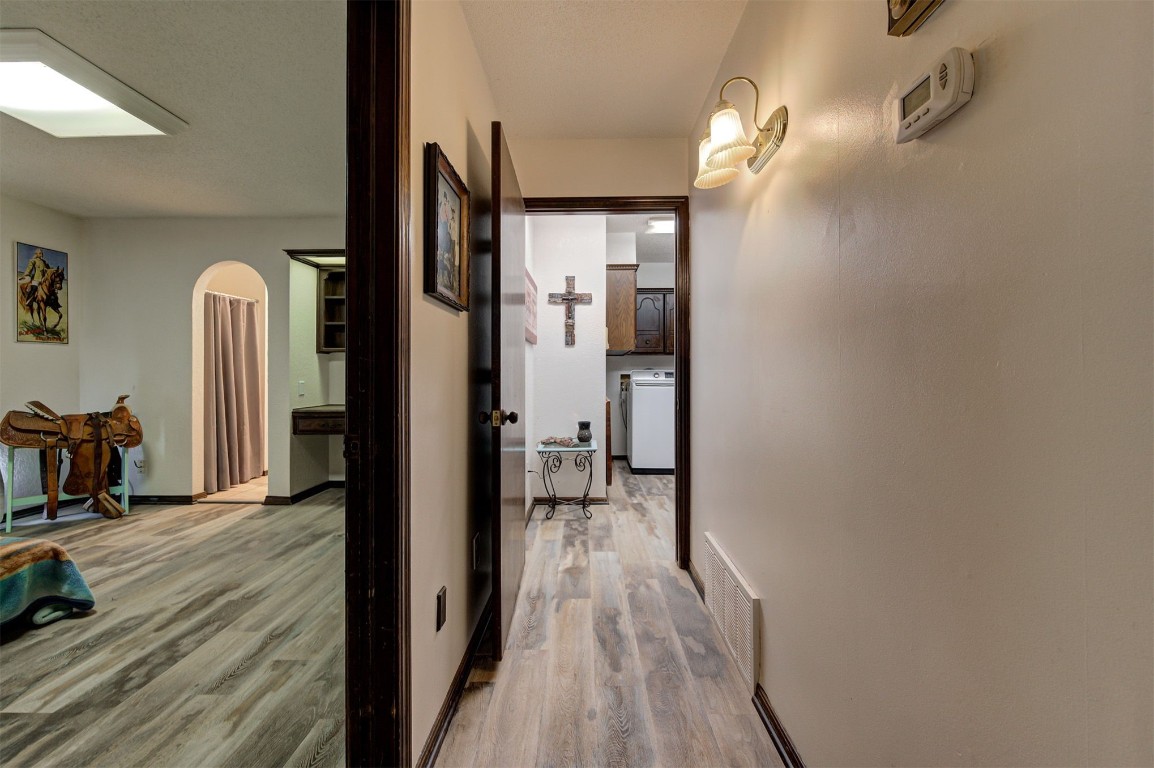1517 S Spring Creek Drive, Mustang, OK 73064 corridor featuring light hardwood / wood-style flooring