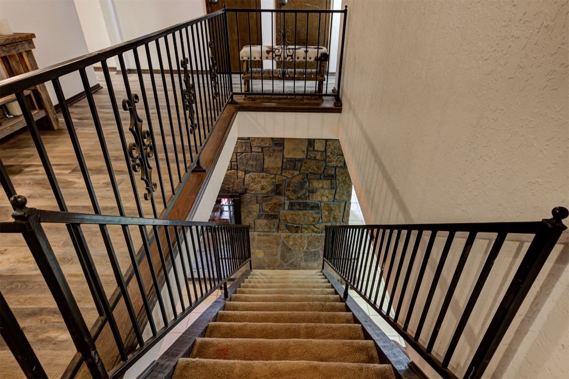 1517 S Spring Creek Drive, Mustang, OK 73064 stairs featuring dark wood-type flooring