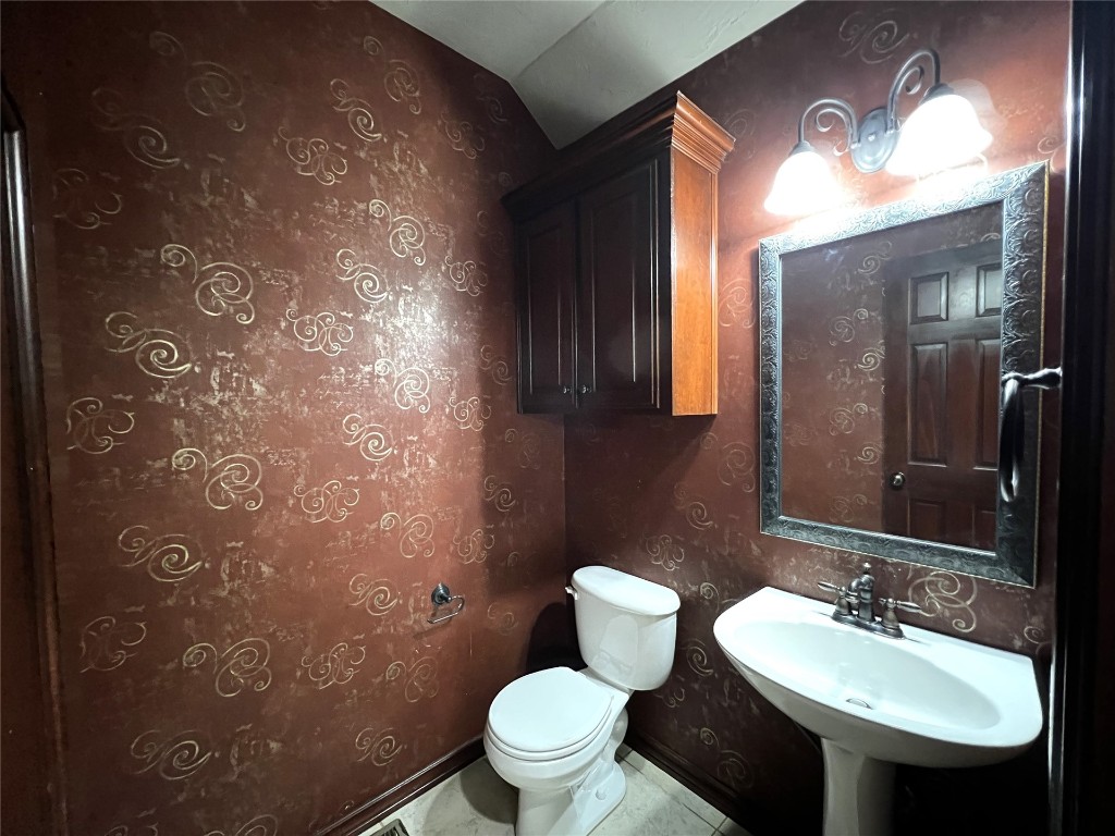 16416 Grace Anne Court, Edmond, OK 73013 bathroom with tile flooring, sink, and toilet