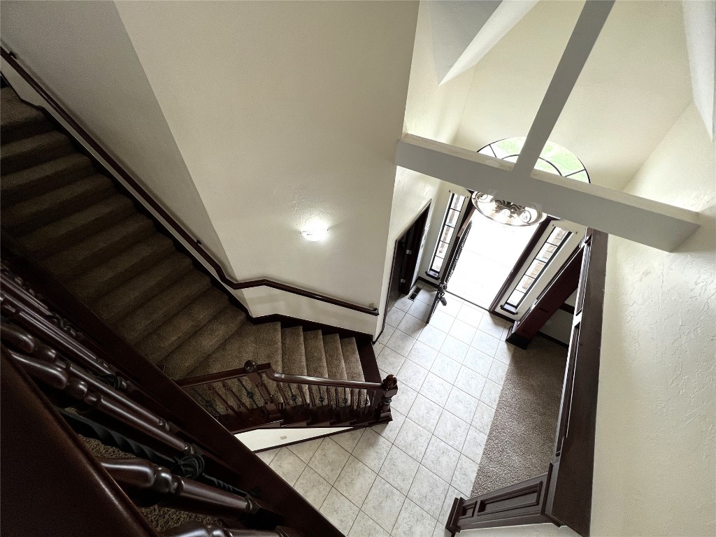 16416 Grace Anne Court, Edmond, OK 73013 stairs with a towering ceiling and tile floors