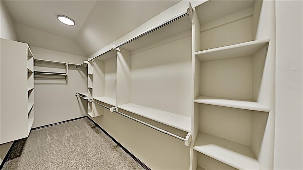 12728 NW 137th Street, Piedmont, OK 73078 walk in closet with vaulted ceiling and carpet flooring
