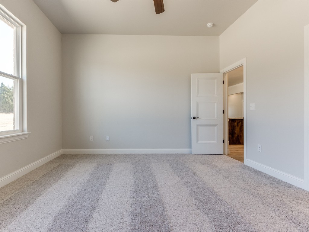 9009 NE 139th Street, Jones, OK 73049 unfurnished room with light carpet and ceiling fan