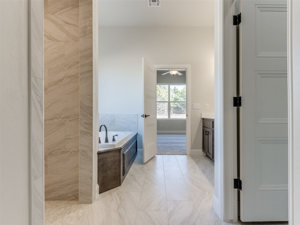 9009 NE 139th Street, Jones, OK 73049 bathroom with vanity, a washtub, and tile flooring