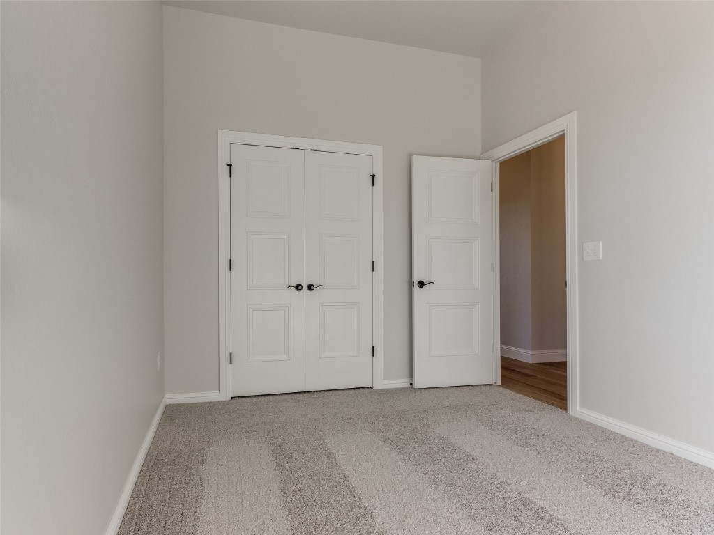 9009 NE 139th Street, Jones, OK 73049 unfurnished bedroom featuring light colored carpet and a closet