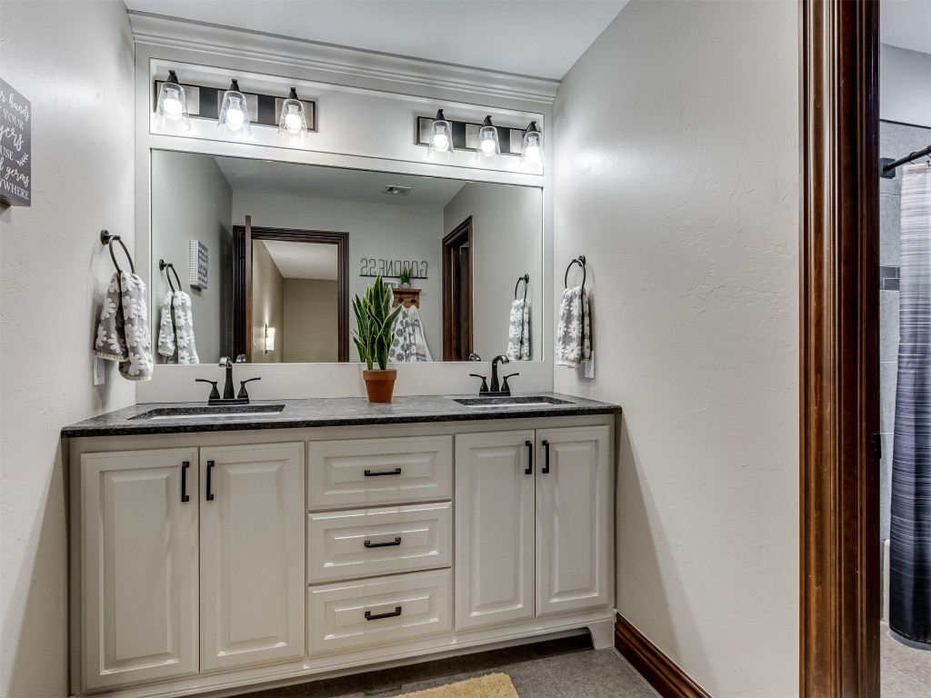 9701 Nawassa Drive, Midwest City, OK 73130 bathroom featuring oversized vanity and dual sinks
