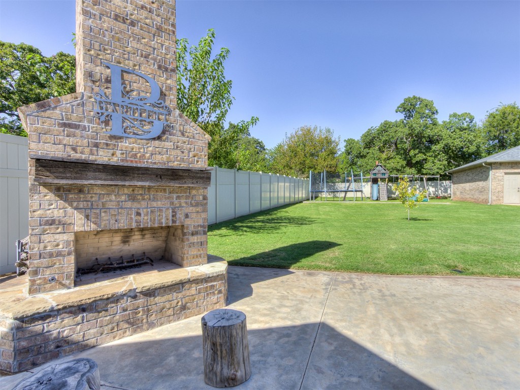 9701 Nawassa Drive, Midwest City, OK 73130 view of terrace with an outdoor brick fireplace