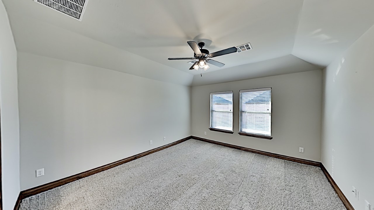 10716 NW 18th Street, Yukon, OK 73099 carpeted spare room featuring ceiling fan and vaulted ceiling