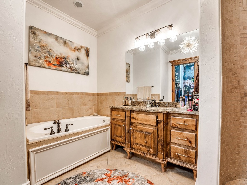 5501 NW 132nd Street, Oklahoma City, OK 73142 bathroom with a tub, ornamental molding, vanity, and tile flooring