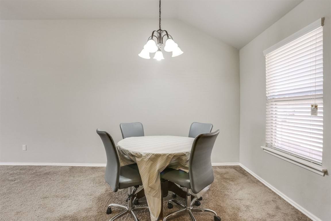 Address Hidden office with light colored carpet, vaulted ceiling, and a wealth of natural light