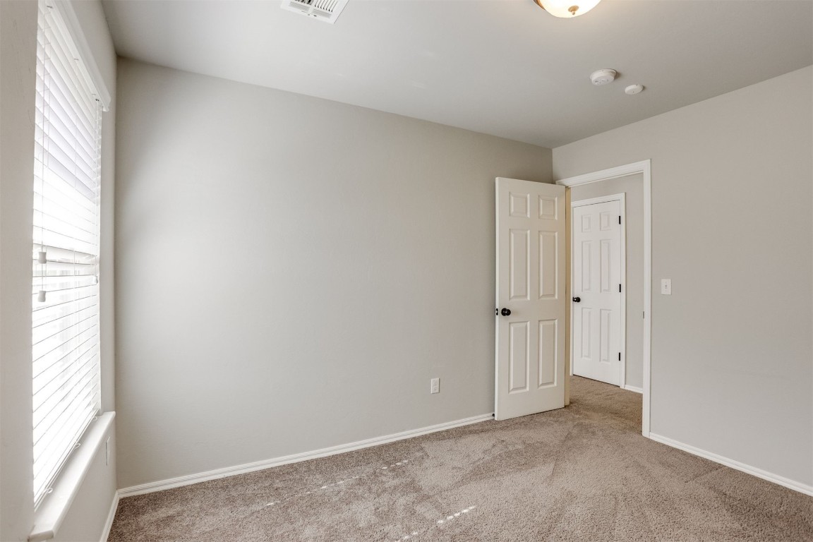 Address Hidden empty room featuring plenty of natural light and light carpet