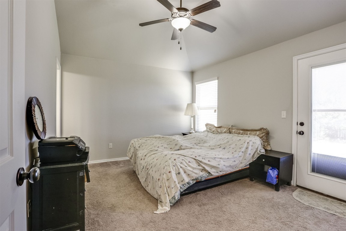 Address Hidden carpeted bedroom with vaulted ceiling and ceiling fan
