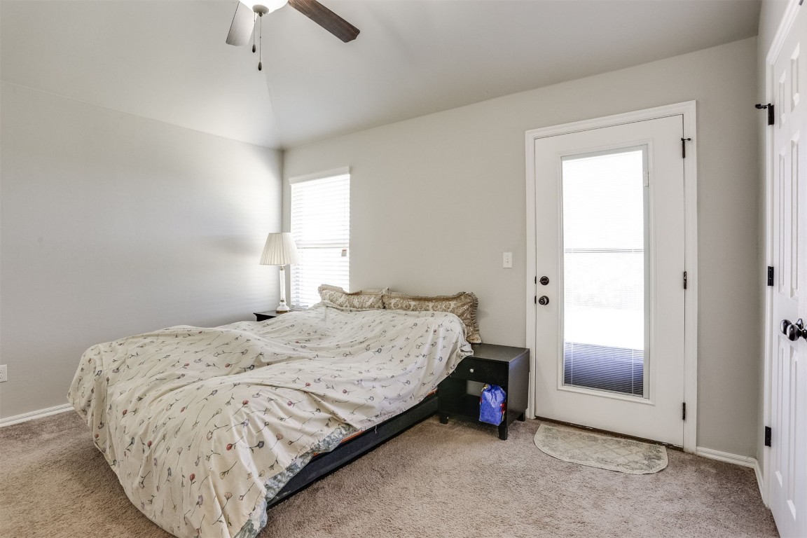 Address Hidden carpeted bedroom featuring ceiling fan and vaulted ceiling
