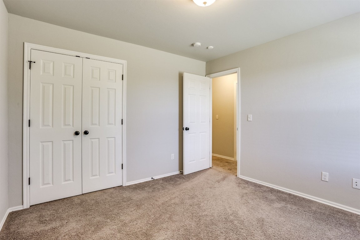 Address Hidden unfurnished bedroom with a closet and dark carpet