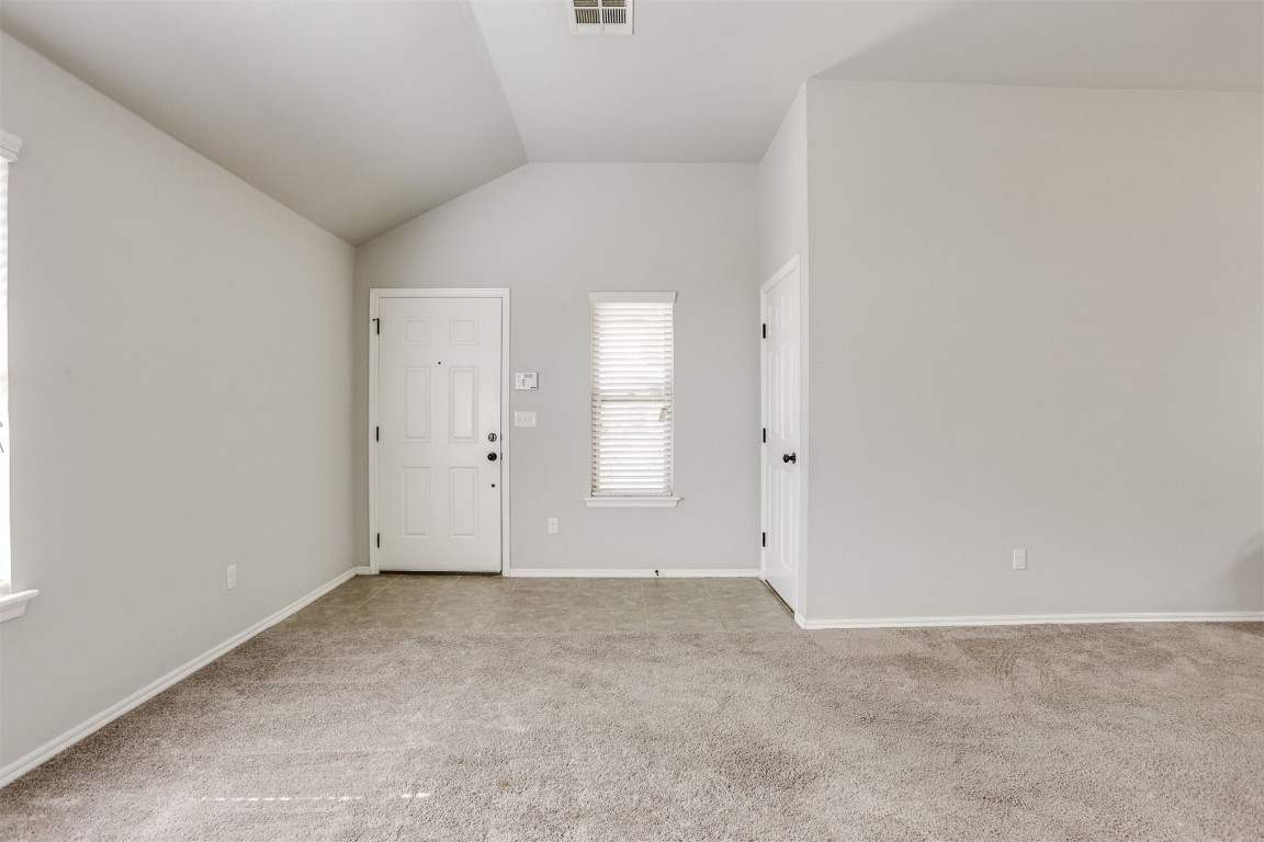 Address Hidden carpeted empty room featuring vaulted ceiling