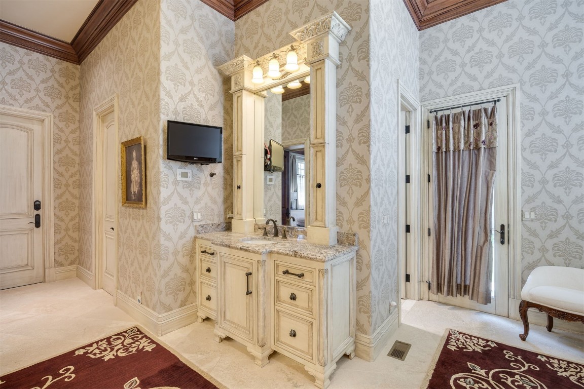 15849 Fairview Farm Boulevard, Edmond, OK 73013 bathroom featuring ornamental molding, vanity, and tile floors