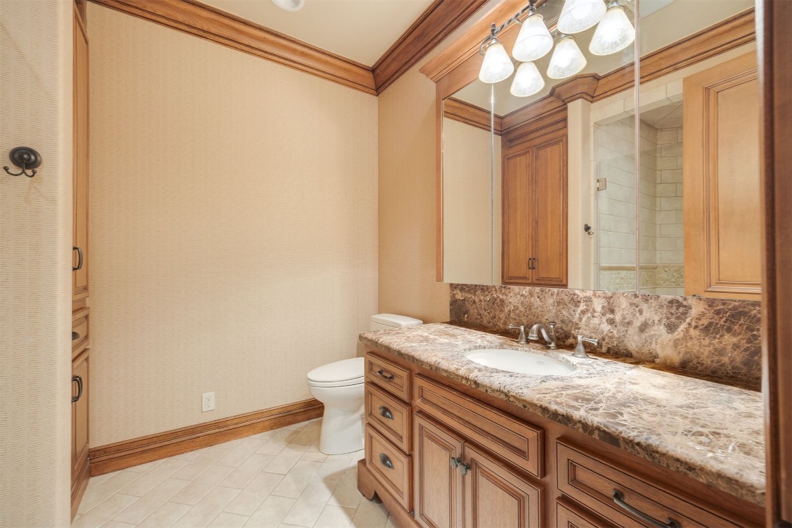15849 Fairview Farm Boulevard, Edmond, OK 73013 bathroom with vanity, crown molding, toilet, and tile flooring