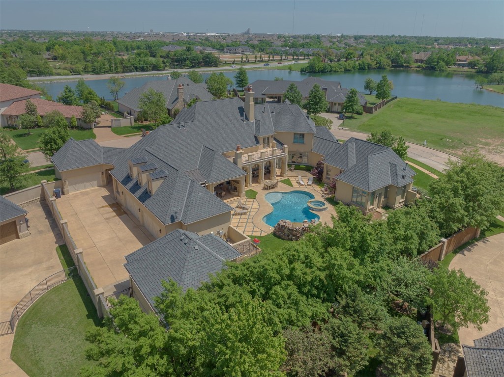 15849 Fairview Farm Boulevard, Edmond, OK 73013 drone / aerial view with a water view