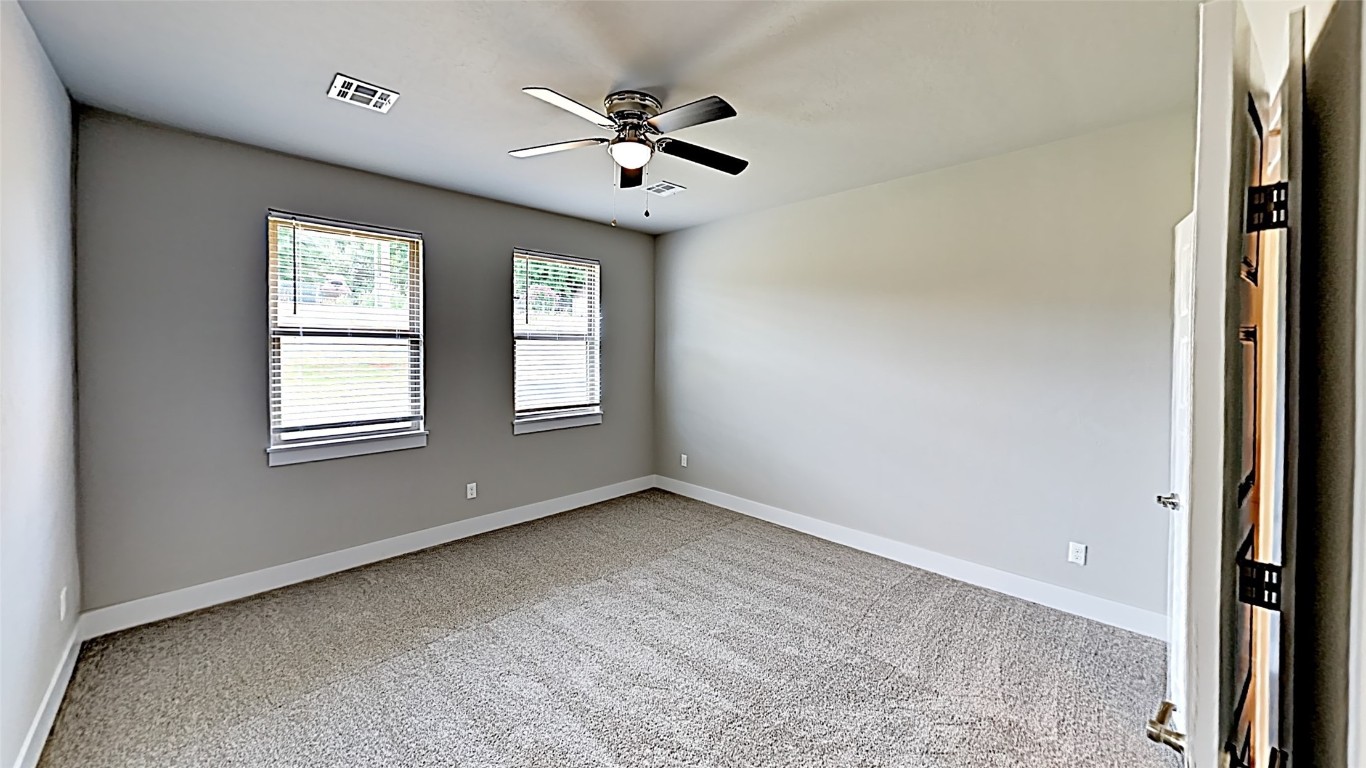 416 Charles Court, Yukon, OK 73099 spare room featuring light carpet and ceiling fan