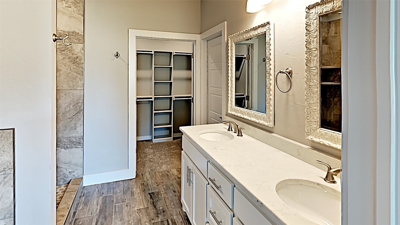 416 Charles Court, Yukon, OK 73099 bathroom featuring hardwood / wood-style flooring and double sink vanity