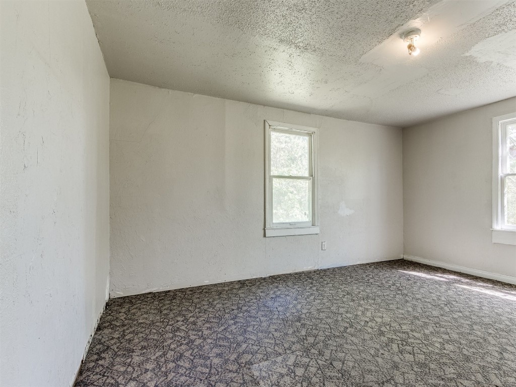 4900 S Blackwelder Avenue, Oklahoma City, OK 73119 carpeted spare room featuring a textured ceiling