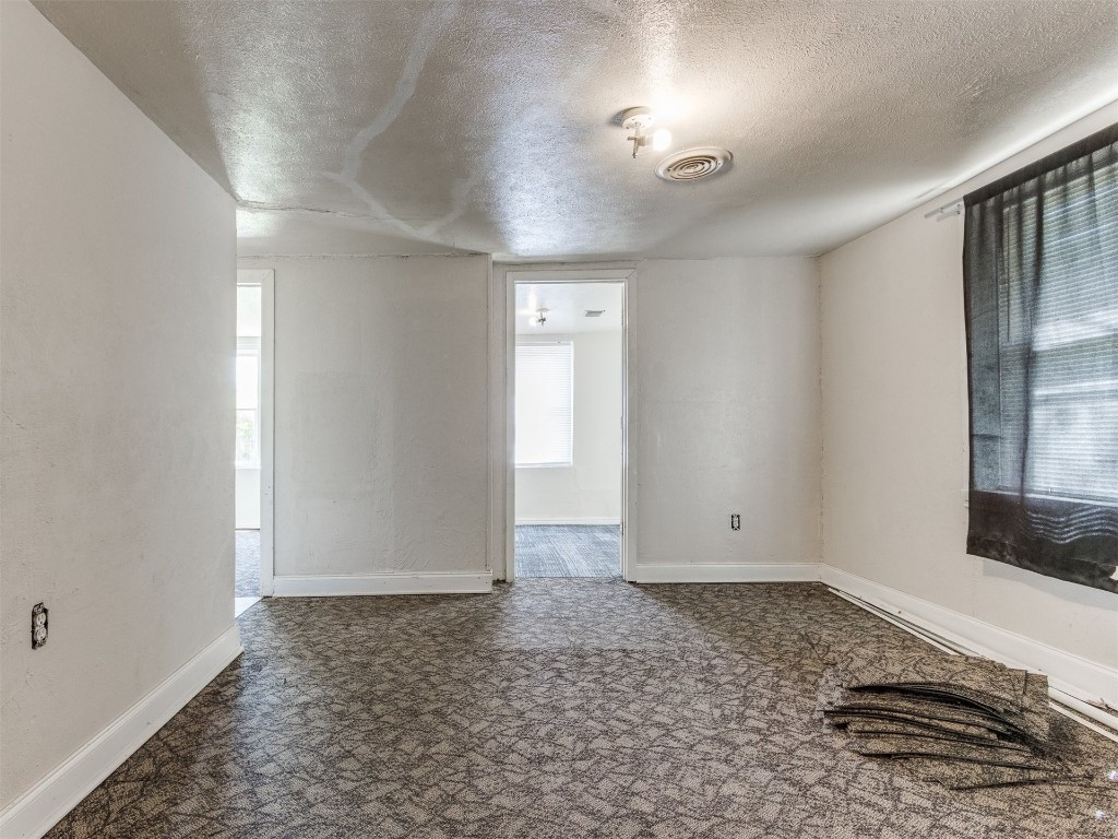 4900 S Blackwelder Avenue, Oklahoma City, OK 73119 empty room featuring a textured ceiling