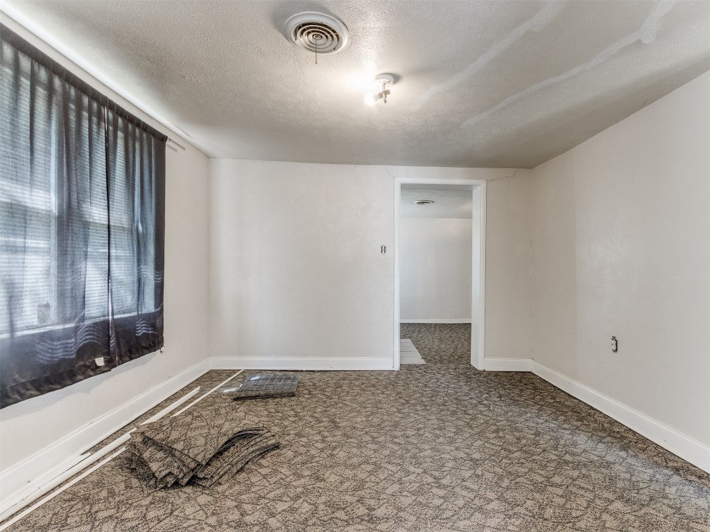 4900 S Blackwelder Avenue, Oklahoma City, OK 73119 empty room with a textured ceiling