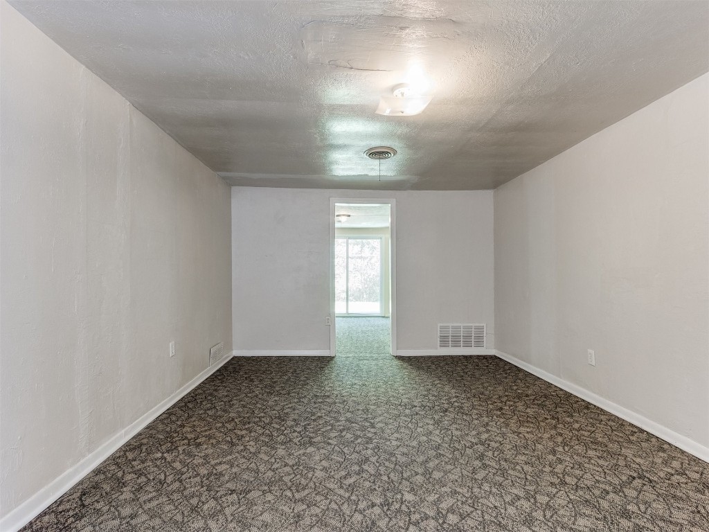 4900 S Blackwelder Avenue, Oklahoma City, OK 73119 empty room with a textured ceiling