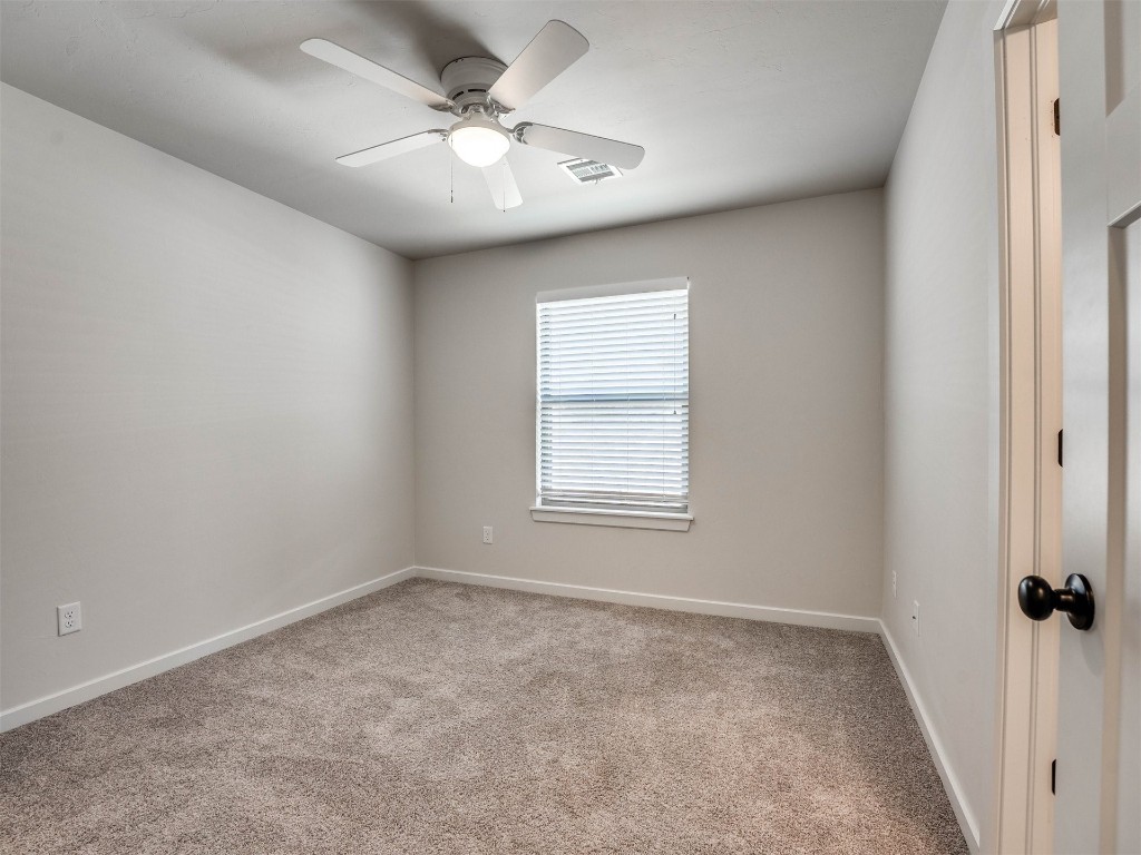 9312 SW 44th Terrace, Oklahoma City, OK 73179 unfurnished room with light colored carpet and ceiling fan