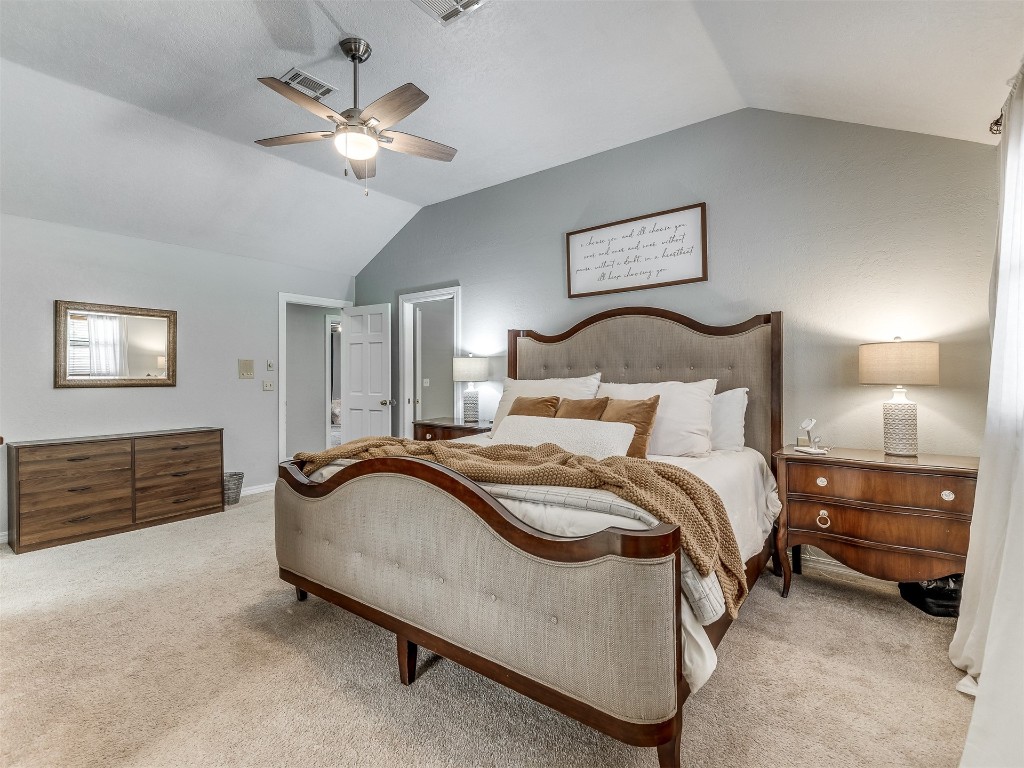 5204 Summit Drive, Edmond, OK 73034 carpeted bedroom featuring lofted ceiling and ceiling fan