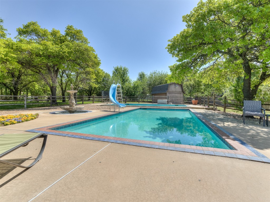 5204 Summit Drive, Edmond, OK 73034 view of pool with a patio and a water slide