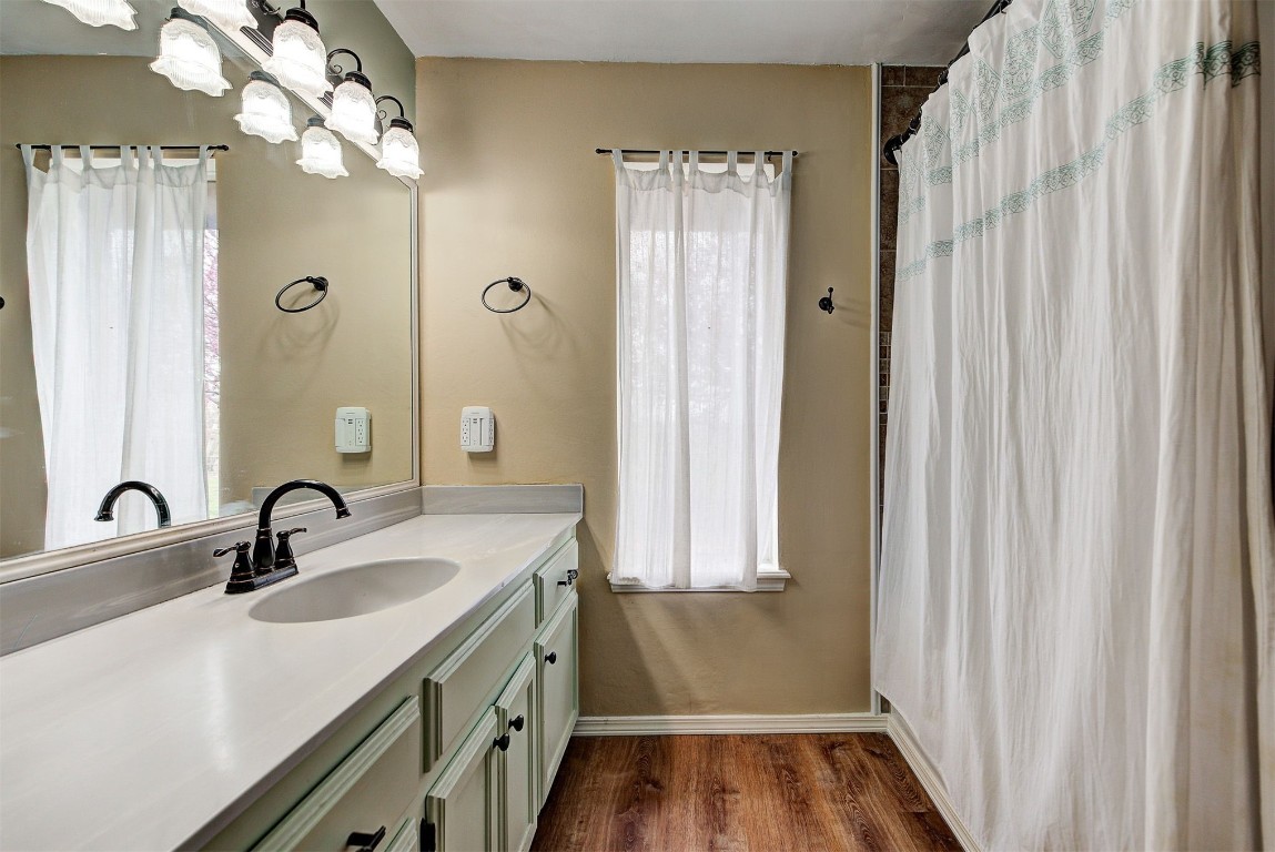 1416 NW Craig Drive, Piedmont, OK 73078 bathroom with wood-type flooring and vanity