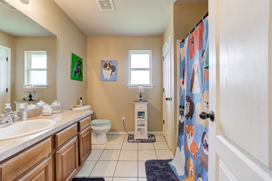 4604 SW 122nd Street, Oklahoma City, OK 73173 bathroom with plenty of natural light, oversized vanity, tile floors, and toilet