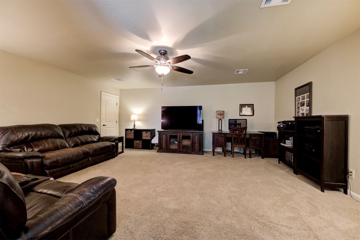 2123 Estancia Circle, Edmond, OK 73034 living room featuring light carpet and ceiling fan