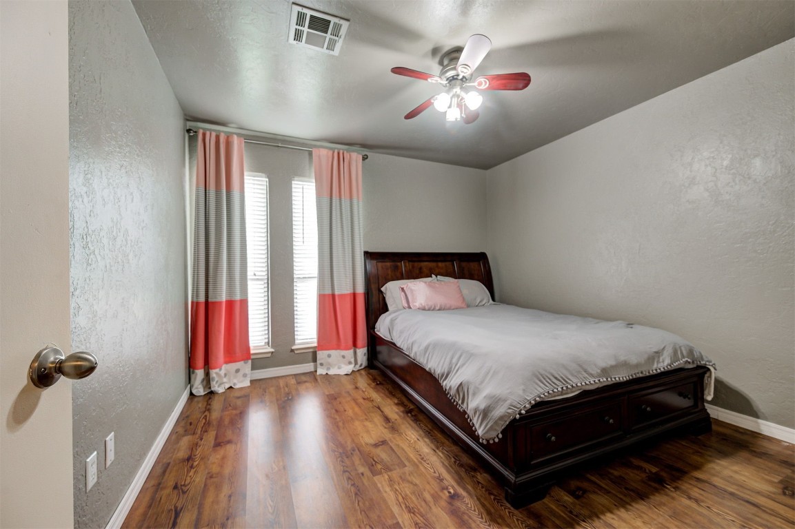 6712 Briarcreek Drive, Oklahoma City, OK 73162 bedroom featuring ceiling fan and dark wood-type flooring