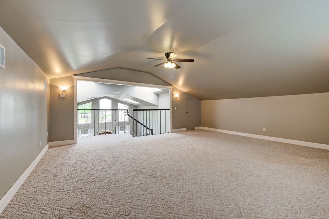 6712 Briarcreek Drive, Oklahoma City, OK 73162 bonus room with light carpet, lofted ceiling, and ceiling fan