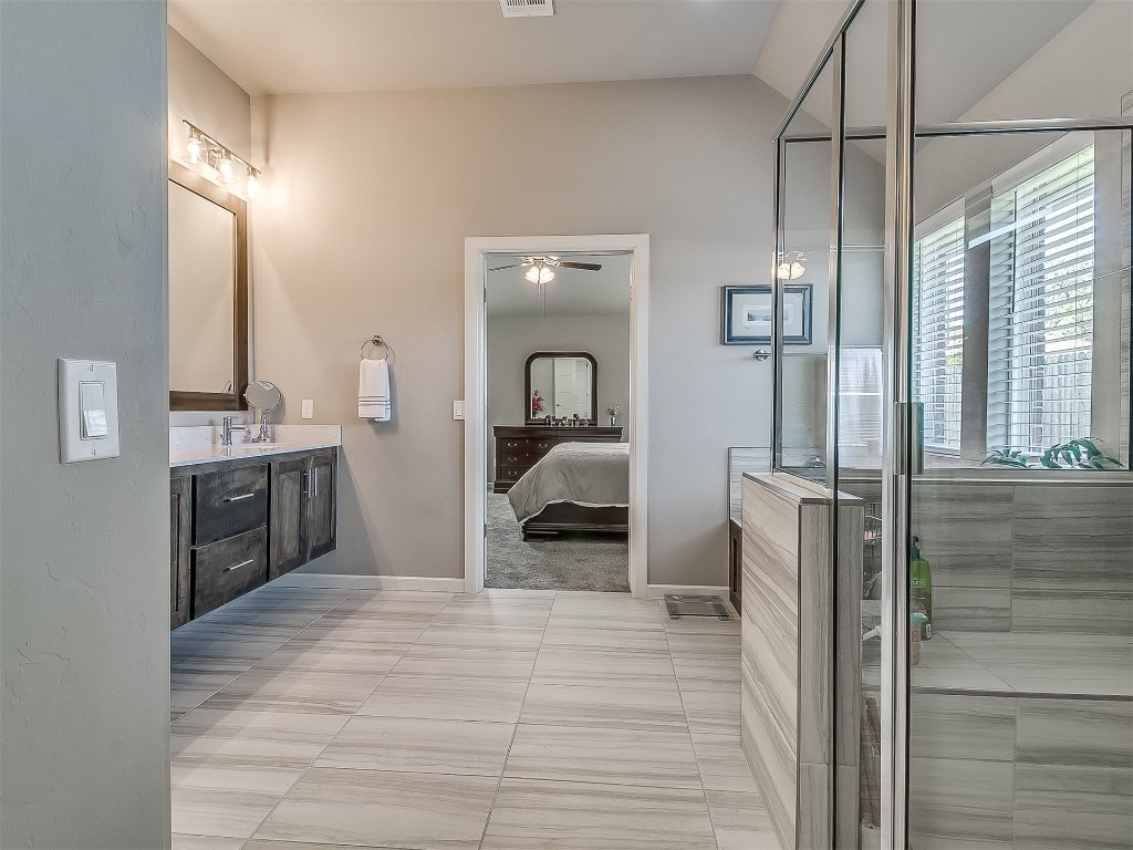 5212 NW 116th Street, Oklahoma City, OK 73162 bathroom featuring ceiling fan, vanity, and tile flooring