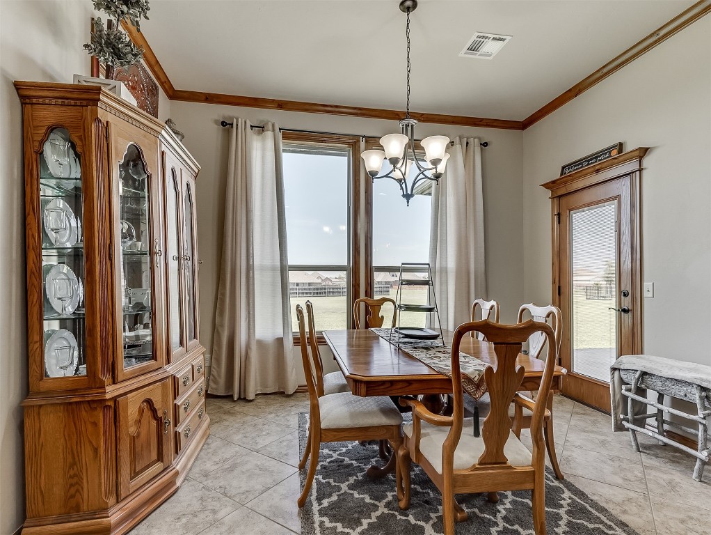 519 Harold Drive, #NE, Piedmont, OK 73078 dining space featuring a wealth of natural light, light tile floors, and a chandelier