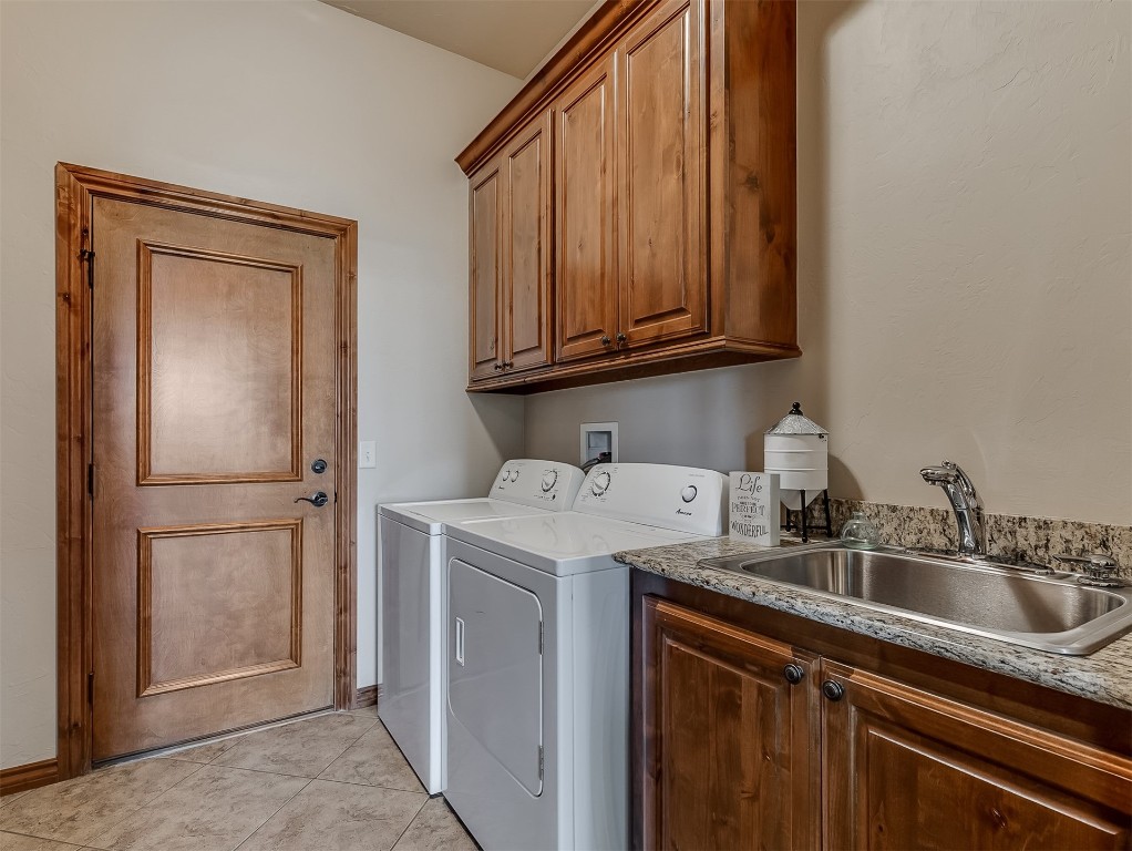 519 Harold Drive, #NE, Piedmont, OK 73078 laundry area with cabinets, light tile floors, sink, washer hookup, and separate washer and dryer
