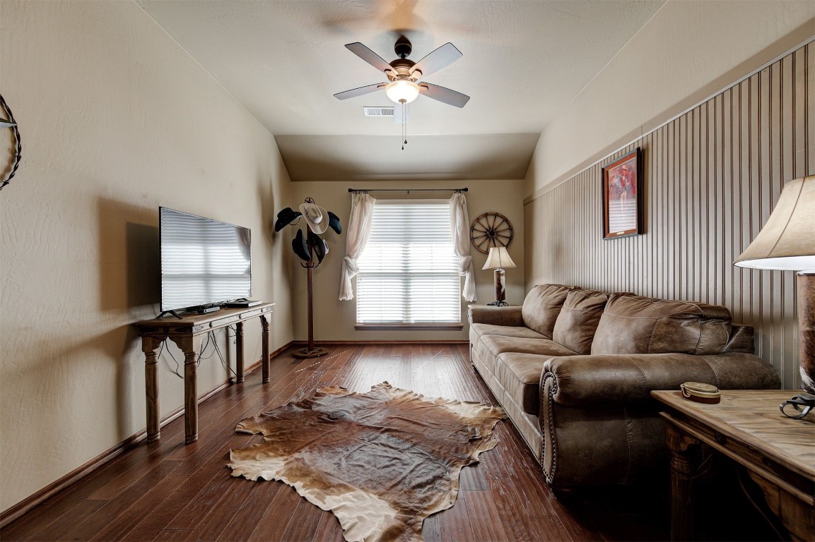 17208 Prado Drive, Oklahoma City, OK 73170 living room featuring ceiling fan, dark wood-type flooring, and vaulted ceiling