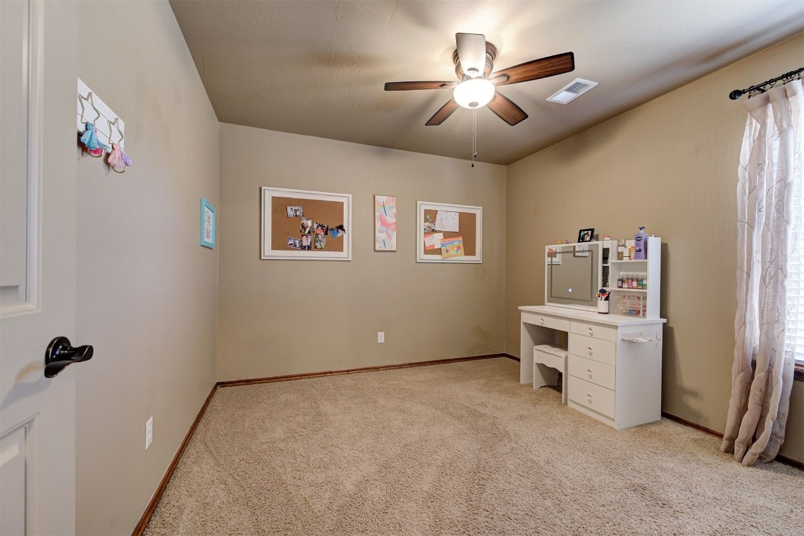 17208 Prado Drive, Oklahoma City, OK 73170 carpeted home office with ceiling fan and a healthy amount of sunlight