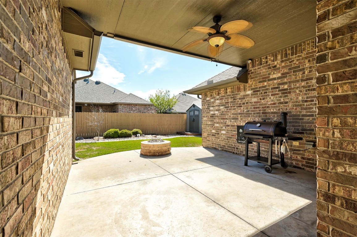 17208 Prado Drive, Oklahoma City, OK 73170 view of patio / terrace featuring ceiling fan, a fire pit, a shed, and grilling area