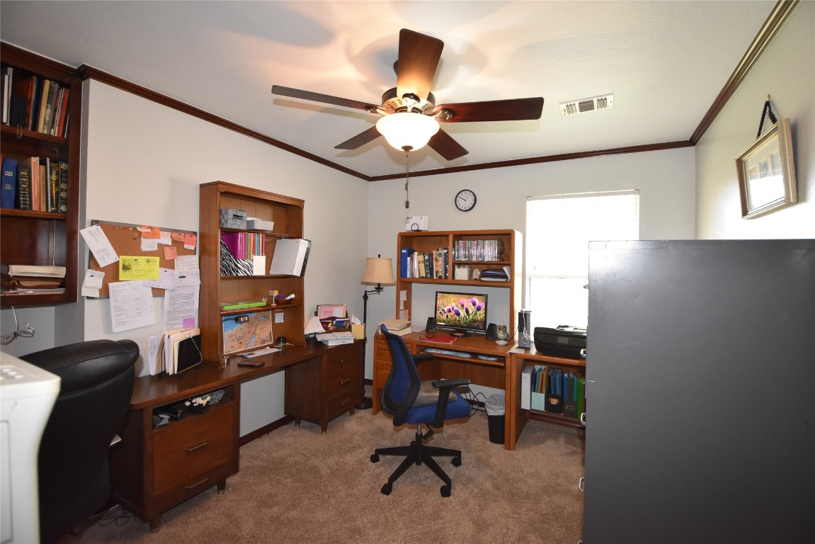 4200 Ainsley Court, Edmond, OK 73034 carpeted office space with ornamental molding and ceiling fan