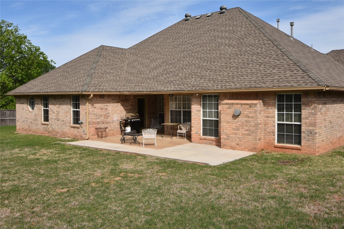 4200 Ainsley Court, Edmond, OK 73034 rear view of property featuring a yard and a patio area