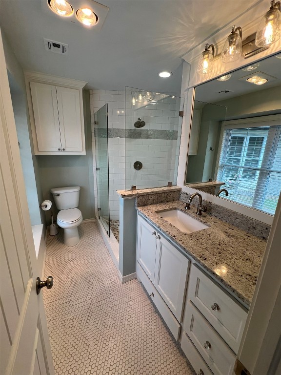 2611 Cambridge Court, Oklahoma City, OK 73116 bathroom featuring a shower with door, toilet, tile floors, and vanity