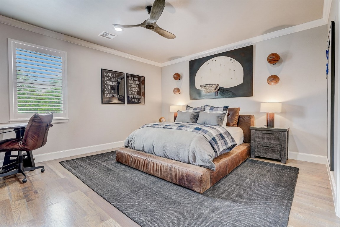 3217 Novara Drive, Arcadia, OK 73007 bedroom featuring ornamental molding, ceiling fan, and light wood-type flooring
