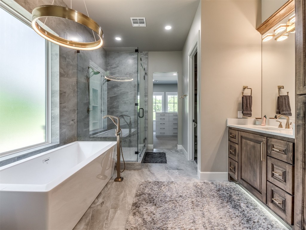 4324 Corridor Drive, Edmond, OK 73034 bathroom featuring vanity with extensive cabinet space, shower with separate bathtub, and tile floors